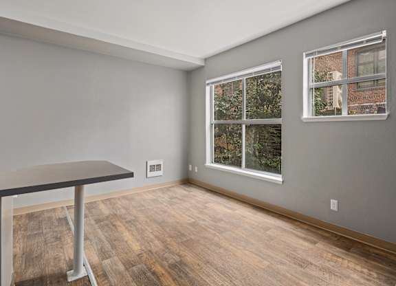 A room with a table and a window.