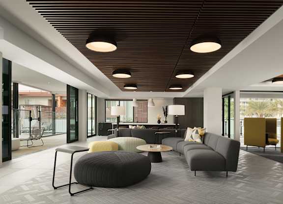 A modern living room with grey and yellow furniture.