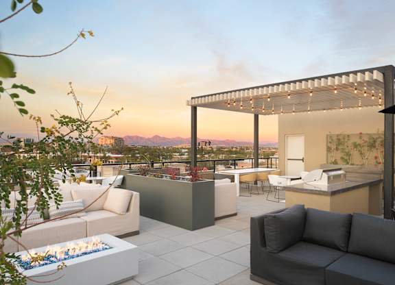A modern outdoor living space with a fire pit and comfortable seating.
