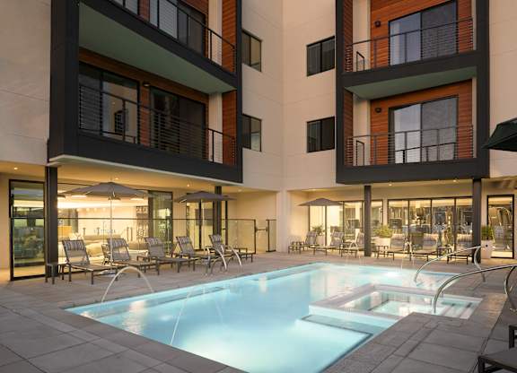 A modern building with a pool in front.