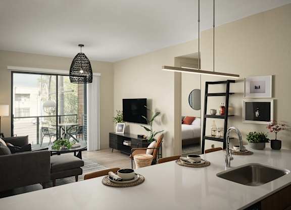 A modern kitchen with a dining area and a living room.