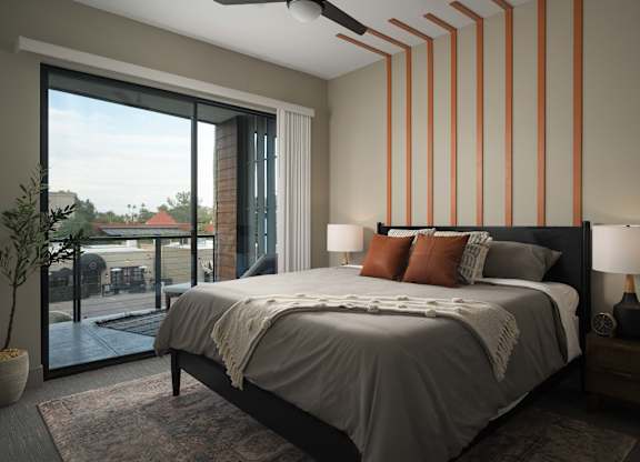 A bedroom with a large bed and a ceiling fan.