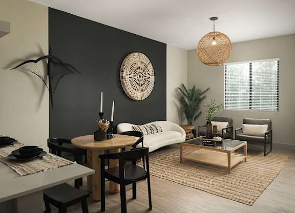A modern living room with a dining table and chairs.