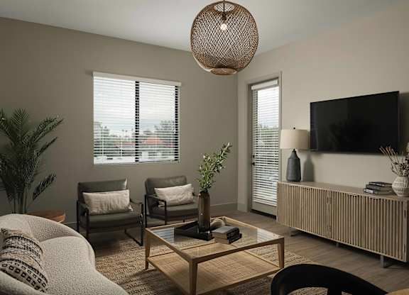 A living room with a sofa, armchair, and a coffee table.