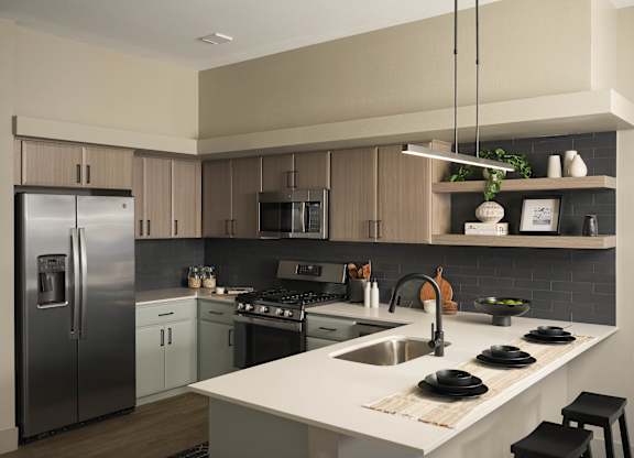 A modern kitchen with a stainless steel refrigerator and a white countertop.