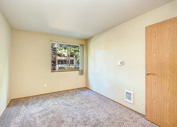 Empty room with a window and a door. at Autumn Village, Milton, WA