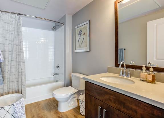 A bathroom with a white toilet, a white sink, and a white bathtub.