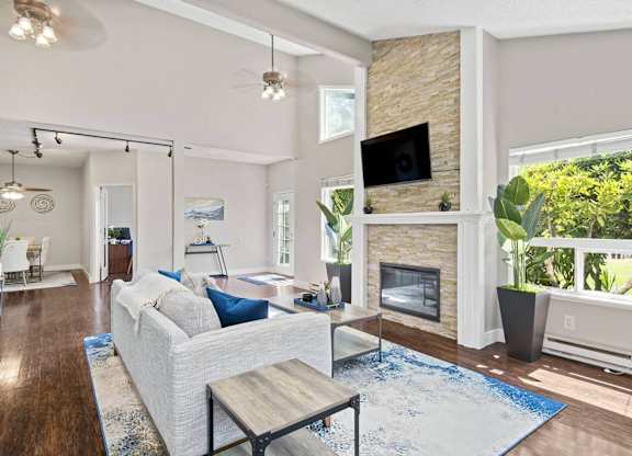A living room with a white couch and a fireplace. at Brookstone, Washington, 98198