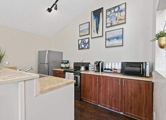 A kitchen with a refrigerator, microwave, and oven. at Brookstone, SeaTac, WA