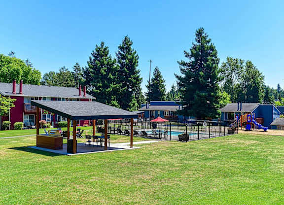 A playground area with a slide and a pavilion. at Brookstone, SeaTac, WA, 98198