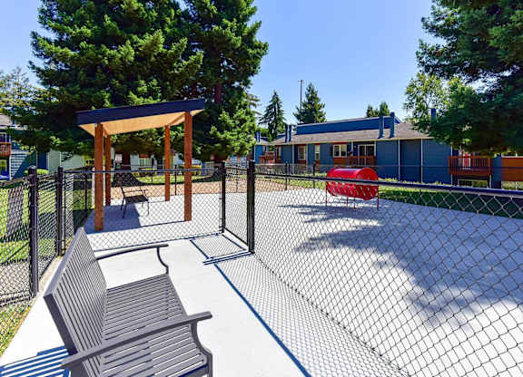 A playground with a swing set and a bench. at Brookstone, Washington, 98198