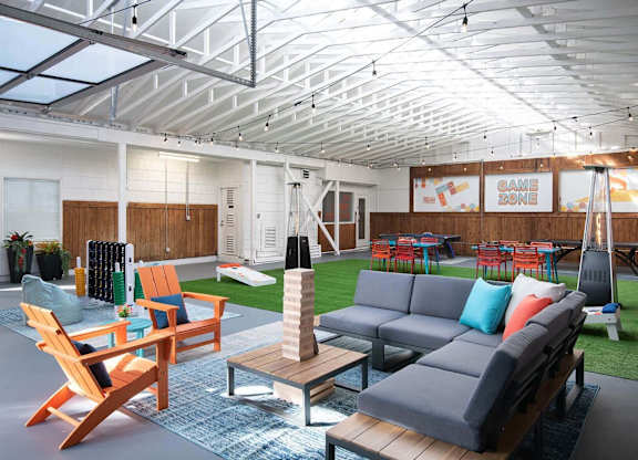 A modern outdoor living space with a glass ceiling and comfortable seating. at Brookstone, SeaTac, WA