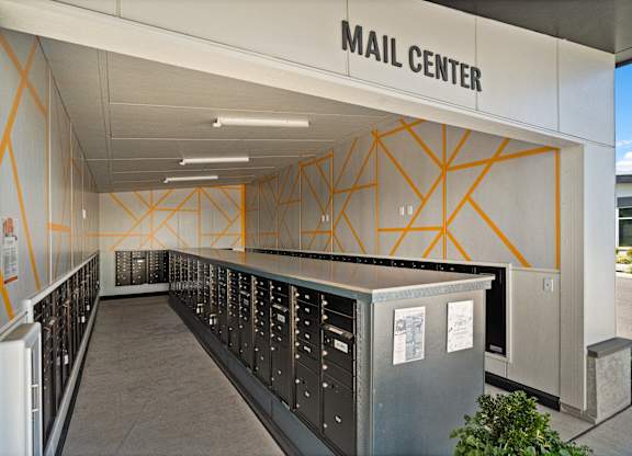 A mail center with a long row of mailboxes.