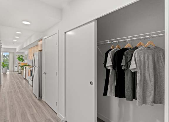 a hallway closet open with shirts hanging at Baldwyn, Seattle, WA