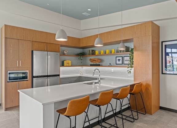 a kitchen with a large island with four stools at Baldwyn, Seattle Washington
