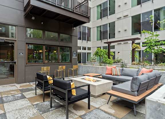 a living room with couches and chairs and a table in front of a building at Baldwyn, Washington, 98125