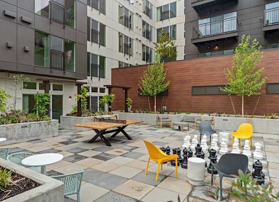 an outdoor patio with tables and chairs at an apartment complex at Baldwyn, Washington