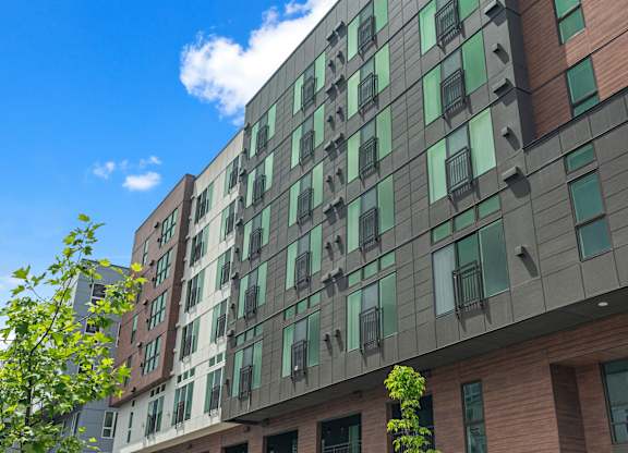 a tall building with green windows and a blue sky at Baldwyn, Washington, 98125