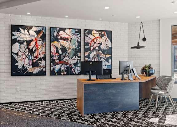 an office with three paintings on the wall and a desk with a computer at Gage On Sixth, Tacoma