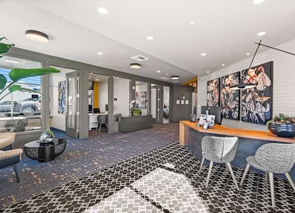 a conference room with a desk and chairs and a large window at Gage On Sixth, Washington, 98465
