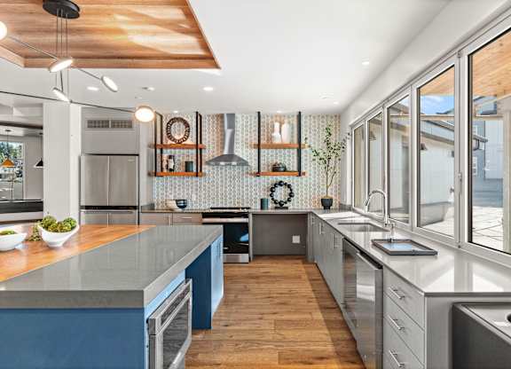 a large kitchen with stainless steel counter tops and stainless steel appliances at Gage On Sixth, Washington, 98465