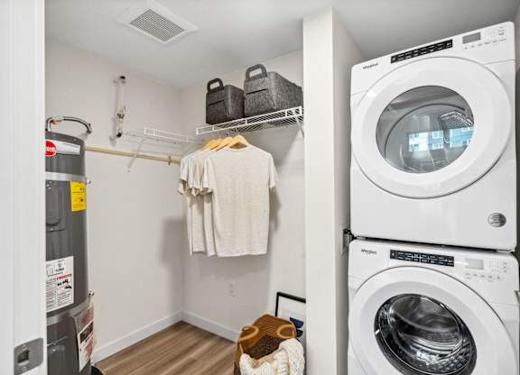 a laundry room with a washing machine and a washer and dryer