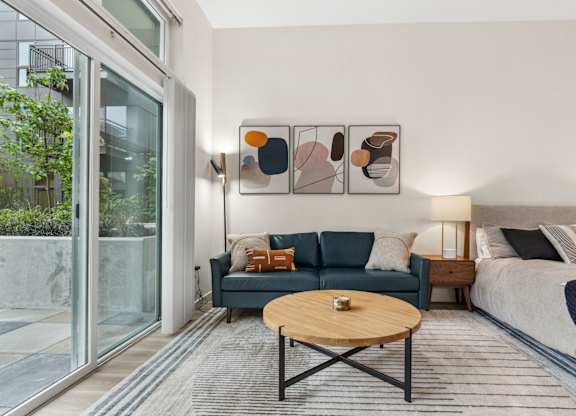 a living room with a blue couch and a coffee table