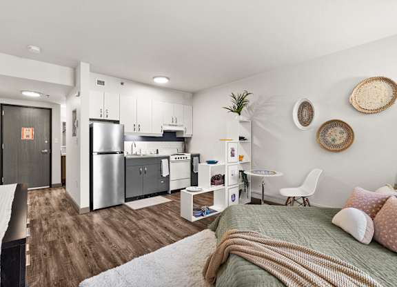 A modern kitchen with a refrigerator, sink, and cabinets.