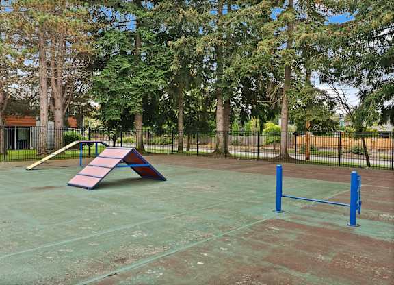 A playground with a slide, swings, and a climbing frame. at Northpoint Apartments, Tacoma, WA