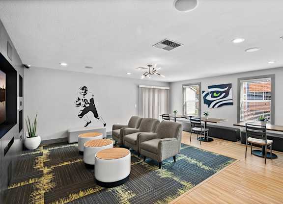 A room with a ceiling fan and a wall mural of a man playing golf. at Northpoint Apartments, Washington, 98407
