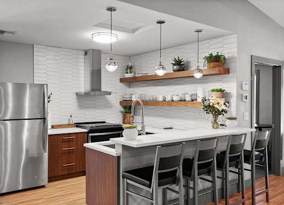 A modern kitchen with a stainless steel refrigerator and a white countertop. at Northpoint Apartments, Tacoma, WA, 98407