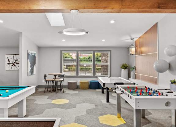 A room with a pool table and a foosball table. at Northpoint Apartments, Washington
