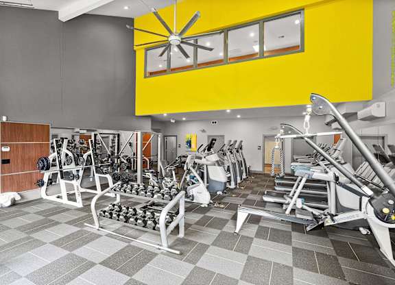 A gym with a variety of equipment including weights and cardio machines. at Northpoint Apartments, Washington