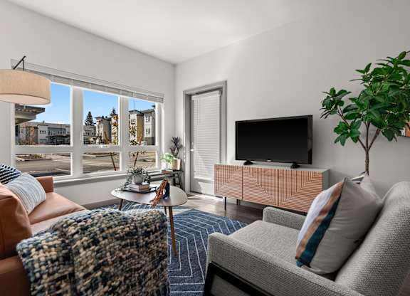 a living room with a couch and a tv and a window at Gage On Sixth, Tacoma, 98406