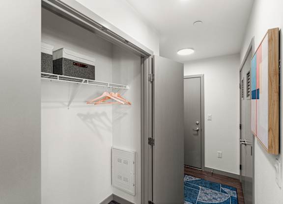a walk in closet with a refrigerator and a washing machine at Gage On Sixth, Tacoma, 98406