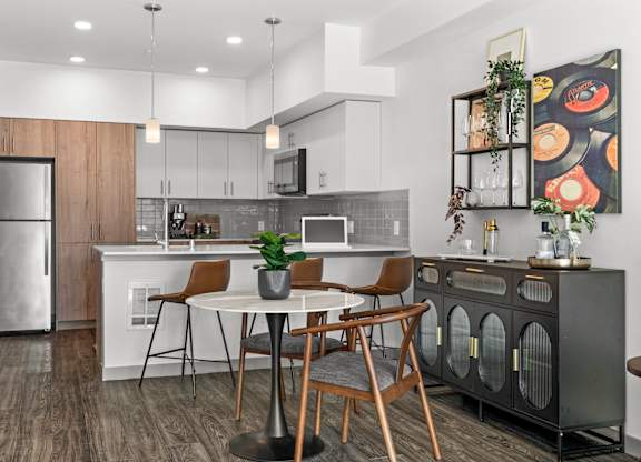 an open kitchen and dining area with a table and chairs at Gage On Sixth, Tacoma, WA 98406