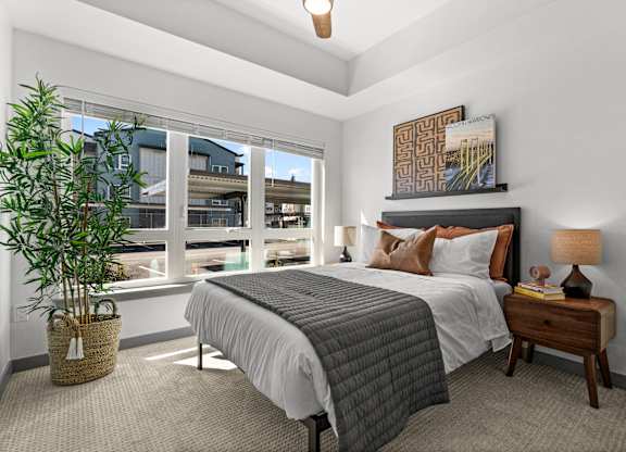 a bedroom with a large window and a bed at Gage On Sixth, Washington