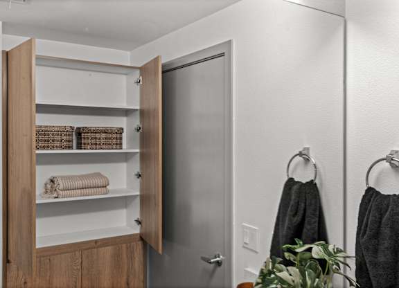 a small bathroom with a closet and a door to the shower at Gage On Sixth, Tacoma