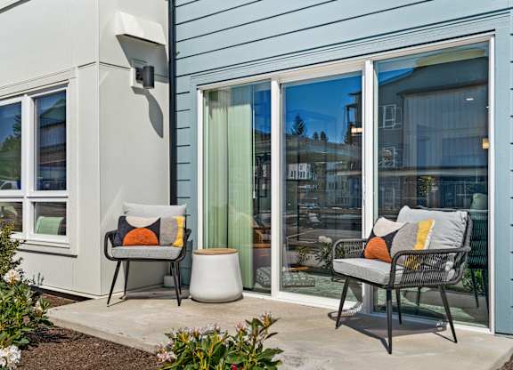 a patio with two chairs and a table outside a house at Gage On Sixth, Washington