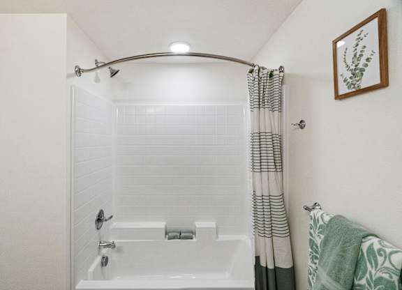 the bathroom has a shower and a tub with a shower curtain at Baldwyn, Washington, 98125
