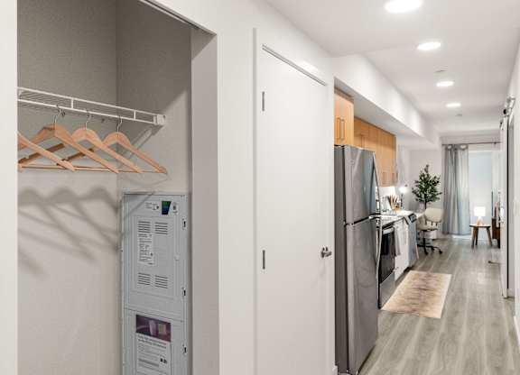 a kitchen and living room with a refrigerator and a washer and dryer at Baldwyn, Seattle, 98125