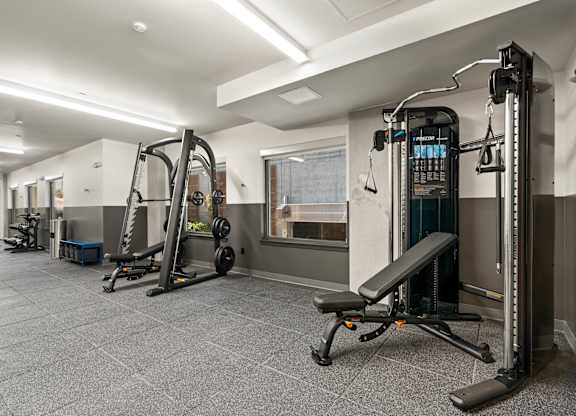 a gym with weights and other equipment in a building with white walls at Baldwyn, Washington