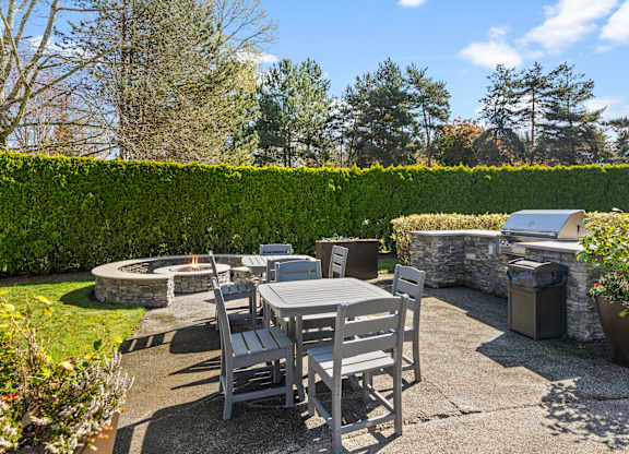 A backyard with a table and chairs.
