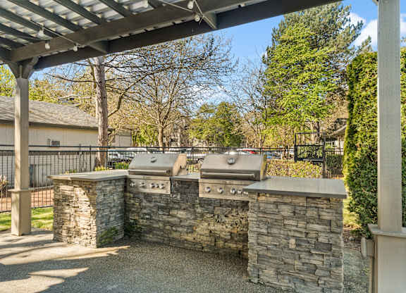 A stone wall with a grill on top.