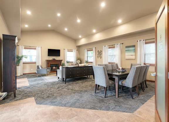 A well-lit dining room with a table set for six.