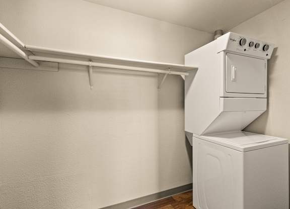A white oven and dryer in a small room.