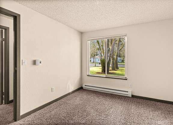 A room with a window showing trees outside.