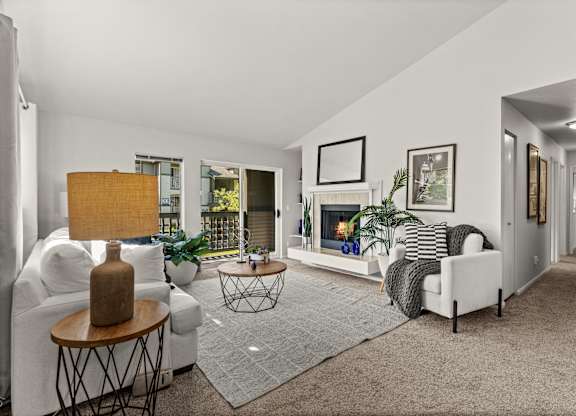 A living room with a fireplace, a couch, and a chair.