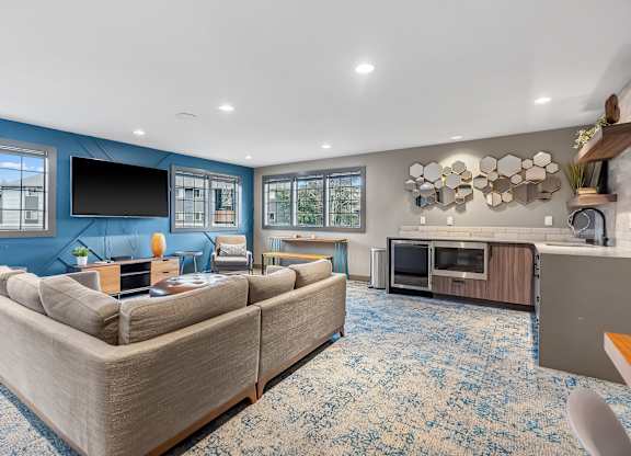 A living room with a large couch and a television.