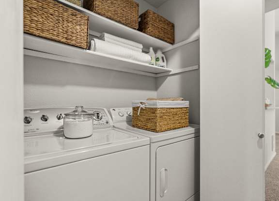 A white kitchen with a stove top oven and a dishwasher.